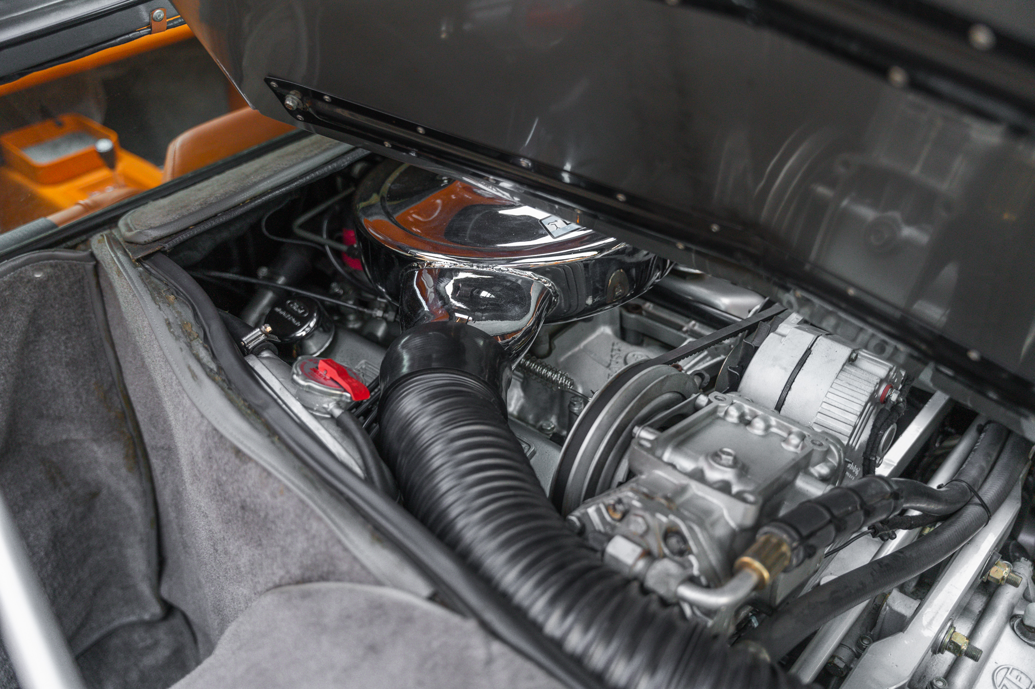 Engine bay of a 1969 gray De Tomaso Mangusta