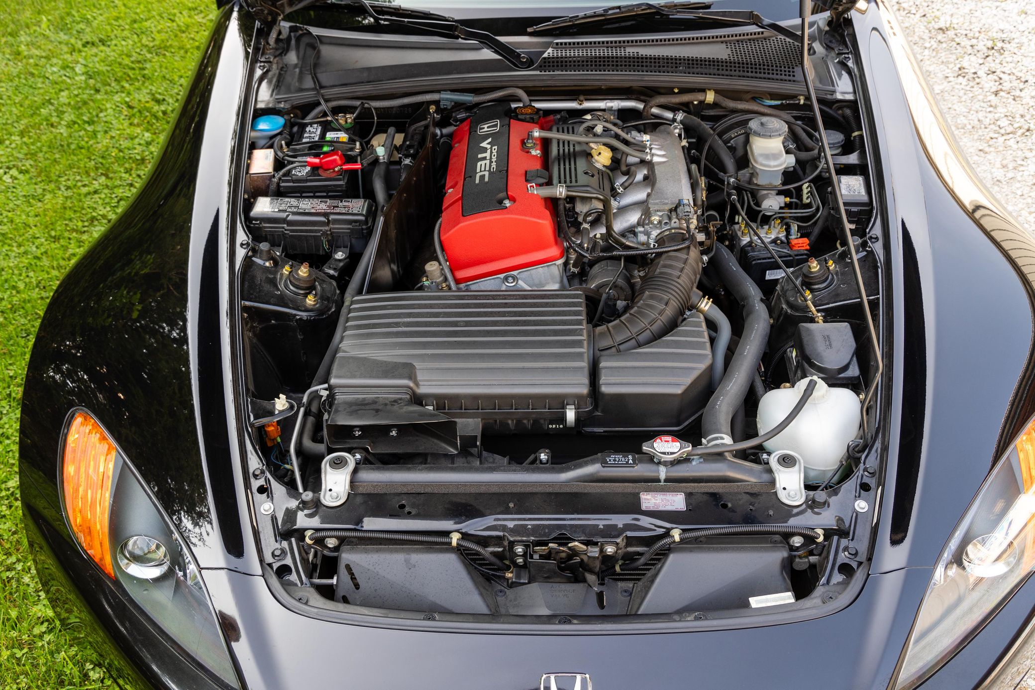 Engine bay of a 2000 black Honda S2000