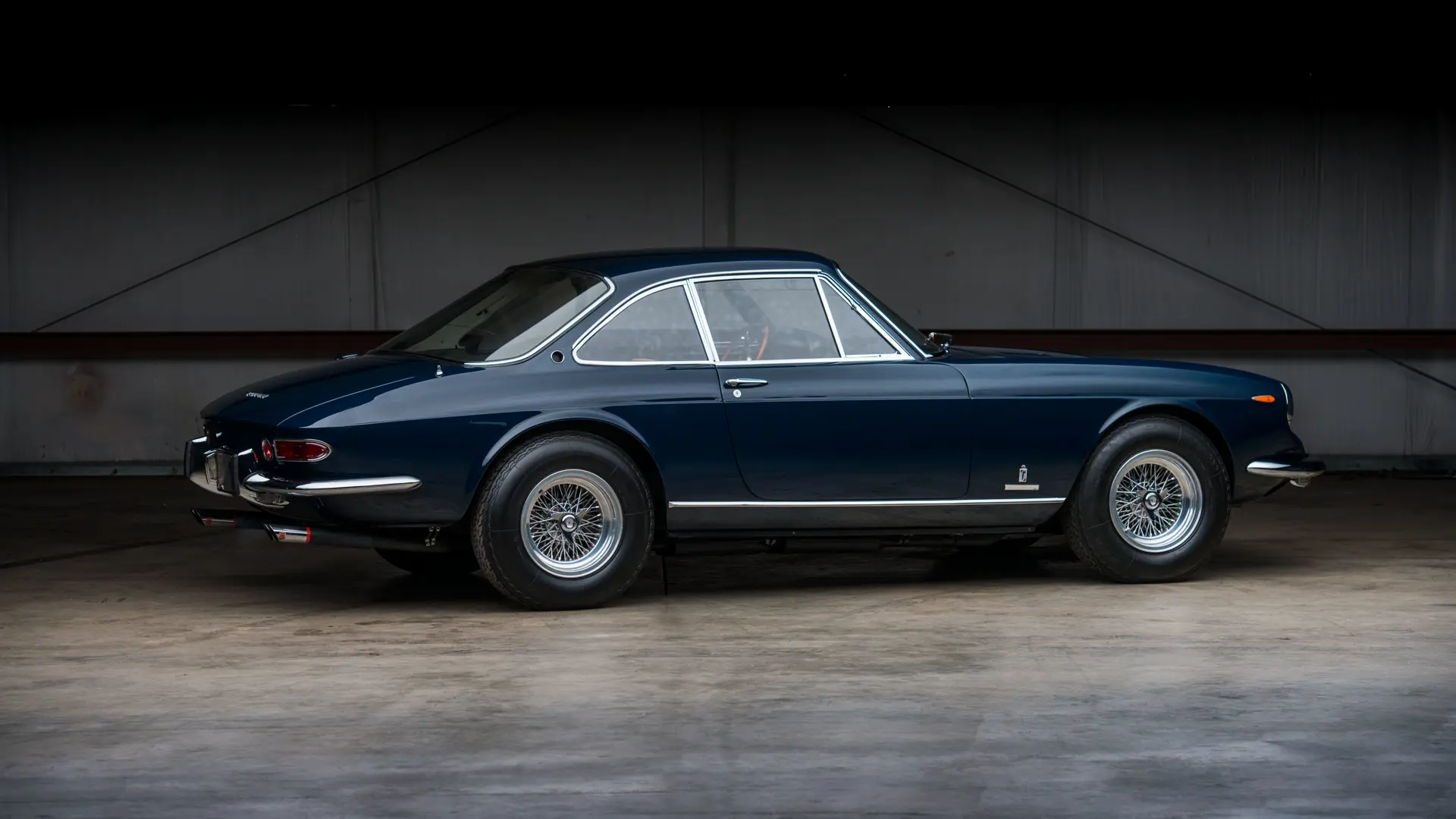 Side view of a 1967 blue Ferrari 330 GTC Speciale