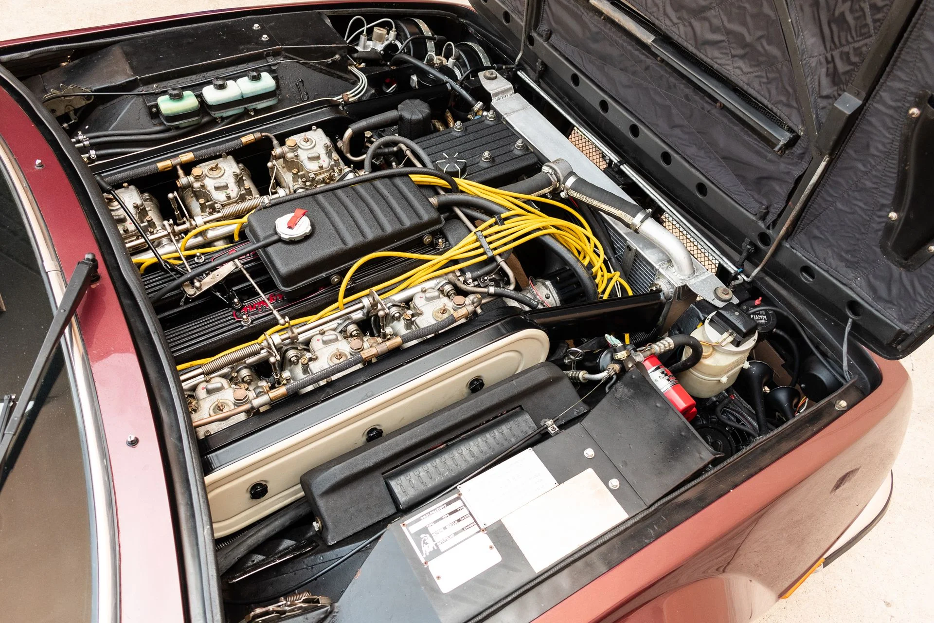 Engine bay of a 1974 burgundy Lamborghini Jarama S