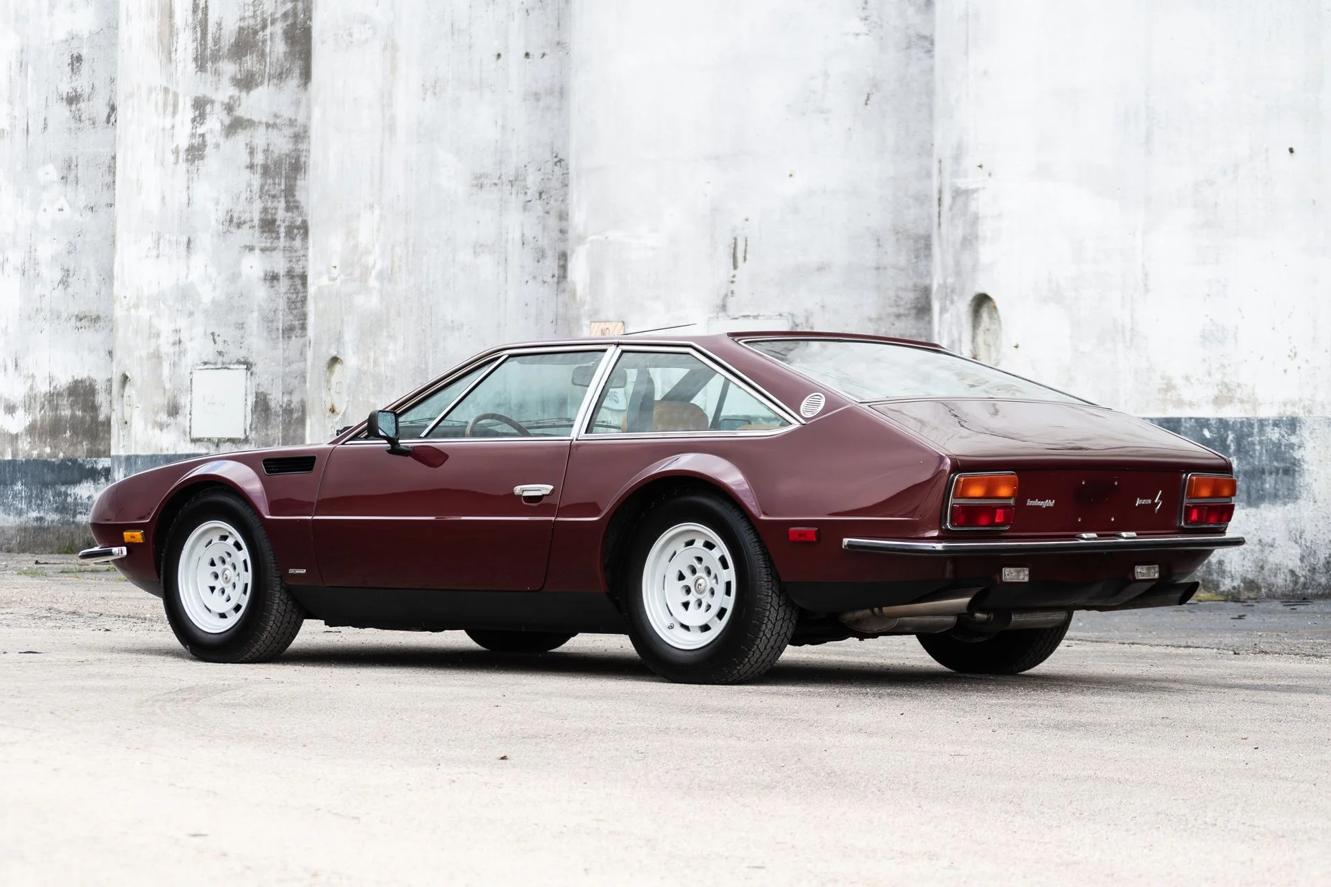 3/4 rear view of a 1974 burgundy Lamborghini Jarama S