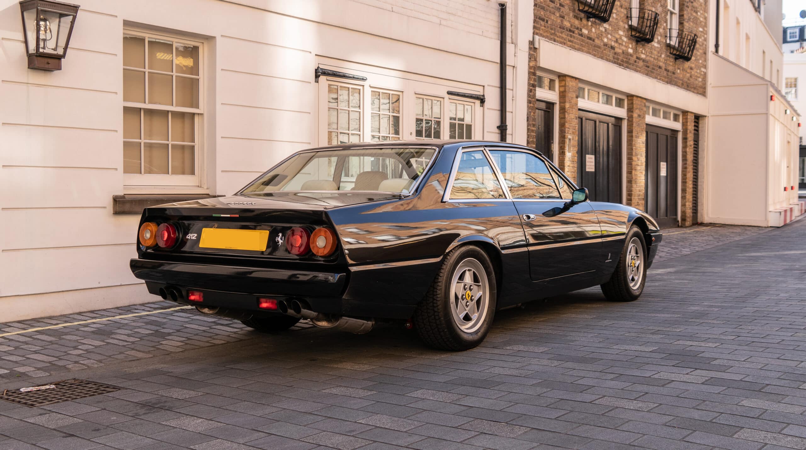 3/4 rear view of a 1988 black Ferrari 412