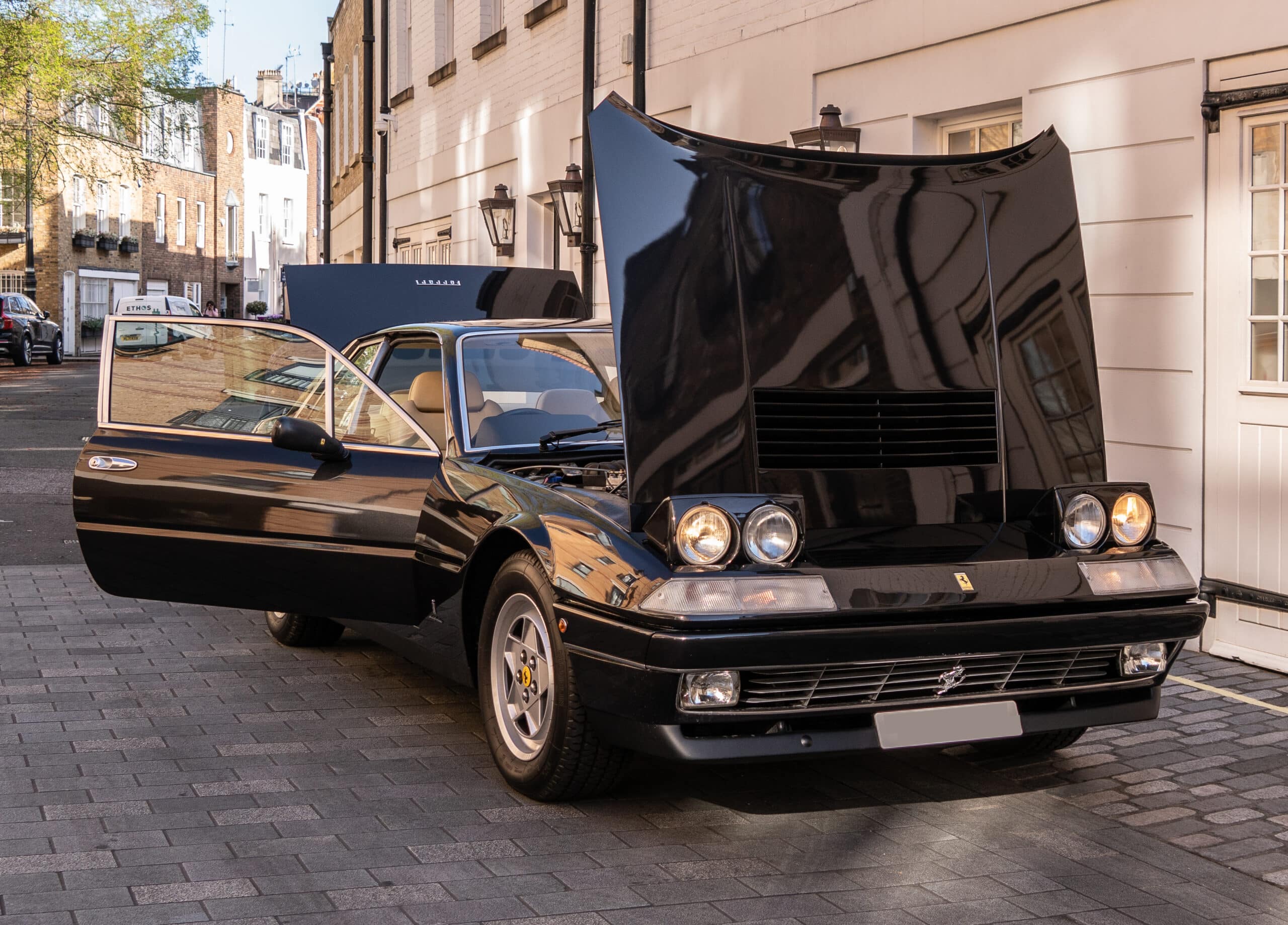 3/4 front view of a 1988 black Ferrari 412