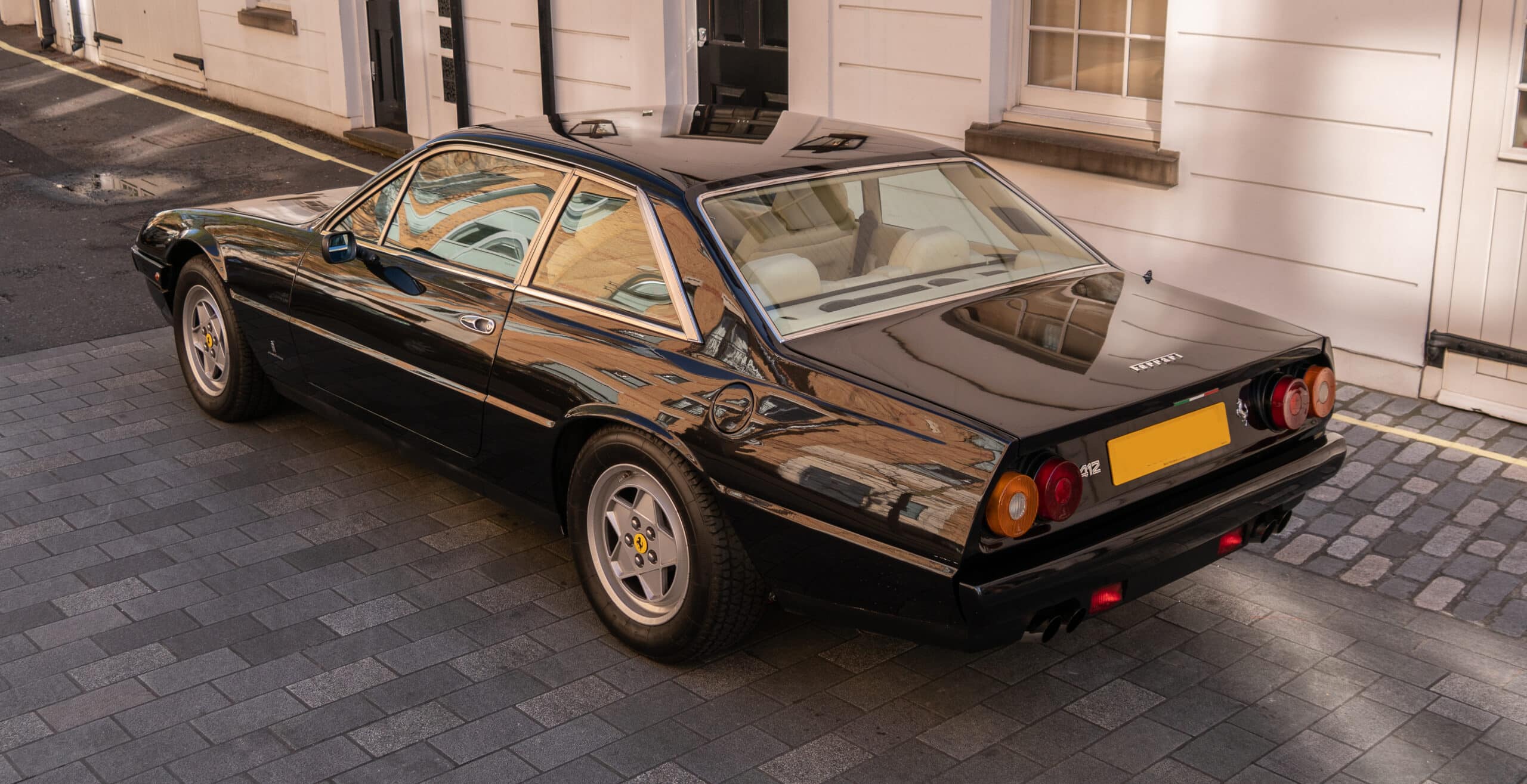 3/4 front view of a 1988 black Ferrari 412