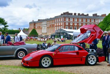 A red Ferrari F40 with open bonnet on display during the Concours of Elegance with Hampton Court Palace in the background