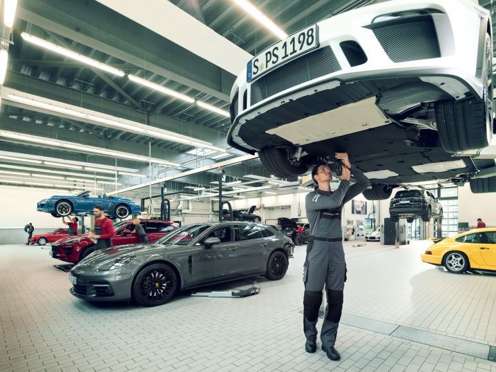 Mechanic inspecting luxury vehicle at shop