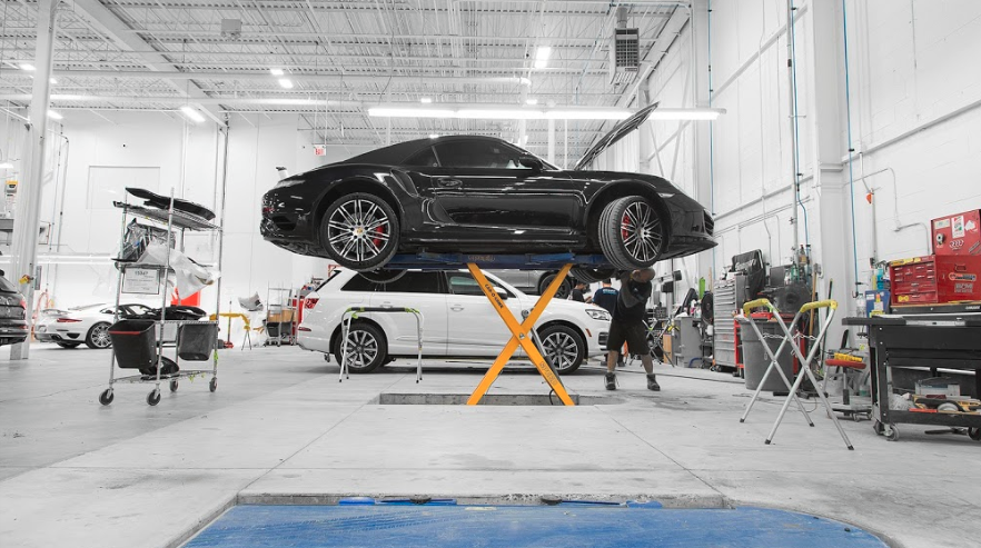 Black Porsche on scissor lift