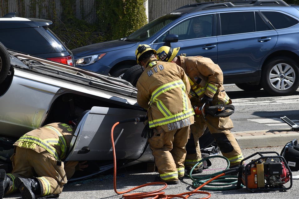 Firemen rescuing someone from accident wreck