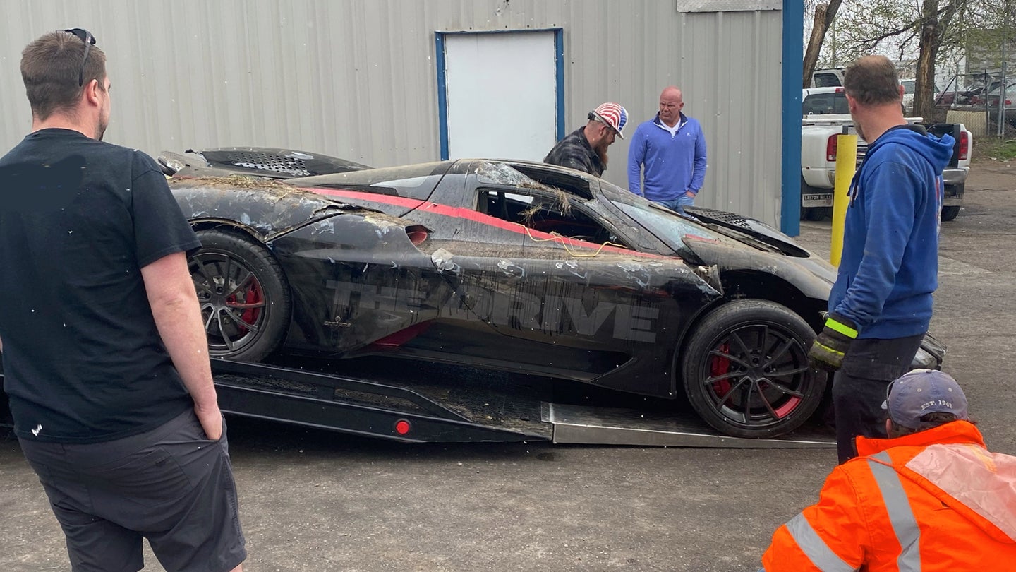 People looking at Exotic car on flatbed truck