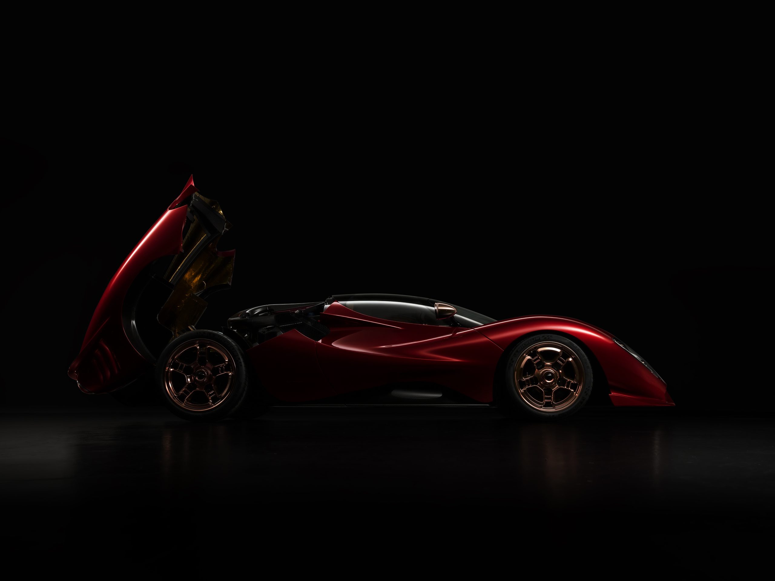 Side view of the P72 hypercar with engine door open