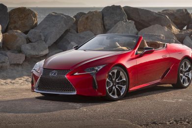 2022 red Lexus LC500 convertible on a rocky beach