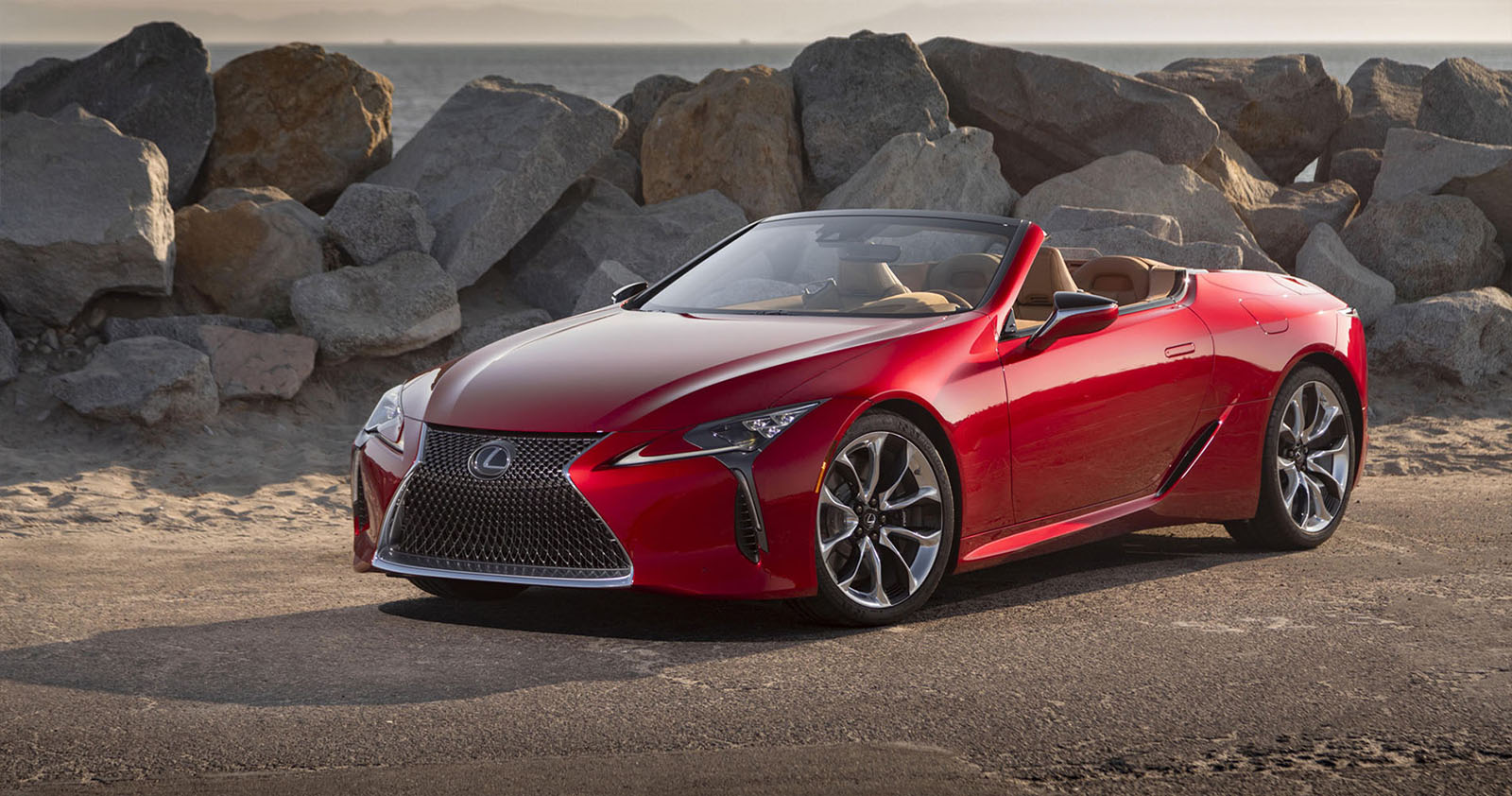 2022 red Lexus LC500 convertible on a rocky beach