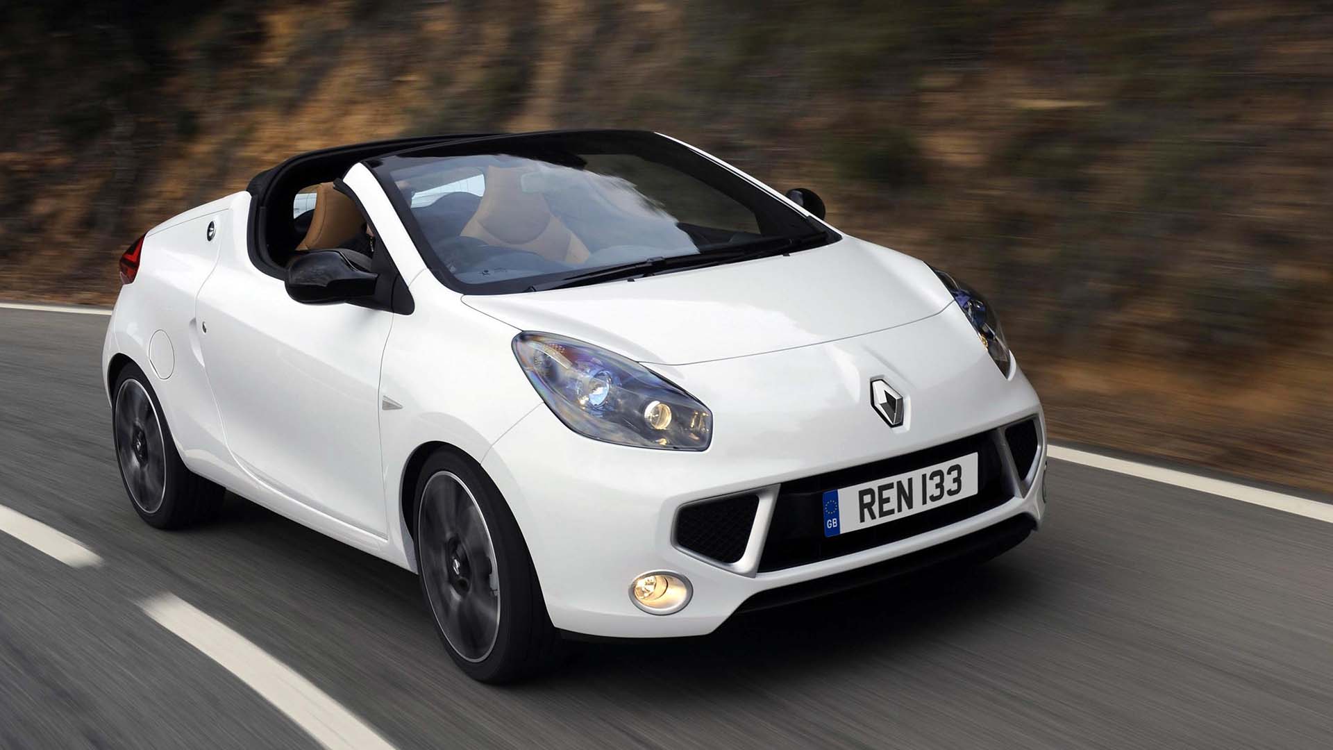 White Renault Wind driving on road at speed