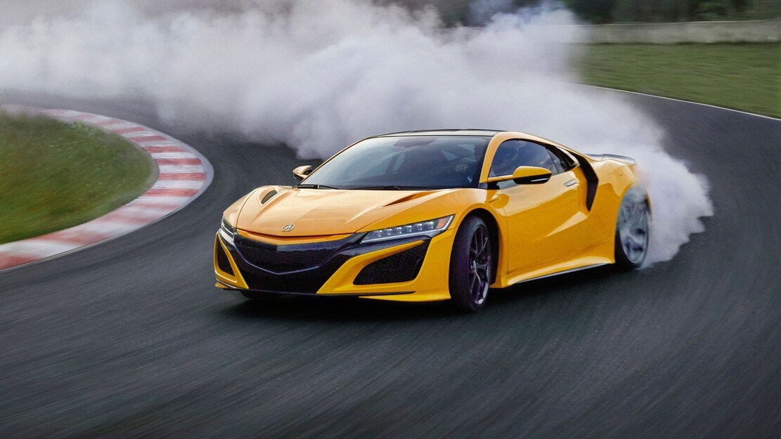 Yellow Second-Gen Acura NSX cornering on track