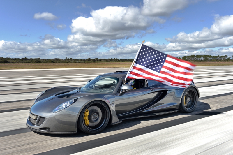 Record-breaking Hennessey Venom GT with driver waving American Flag