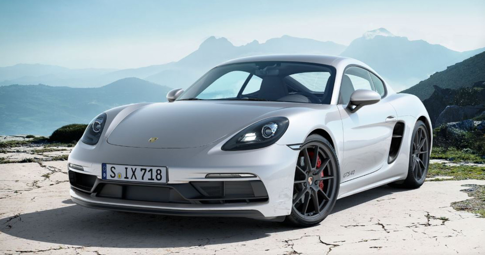 Silver Porsche 718 Cayman GTS with mountain background