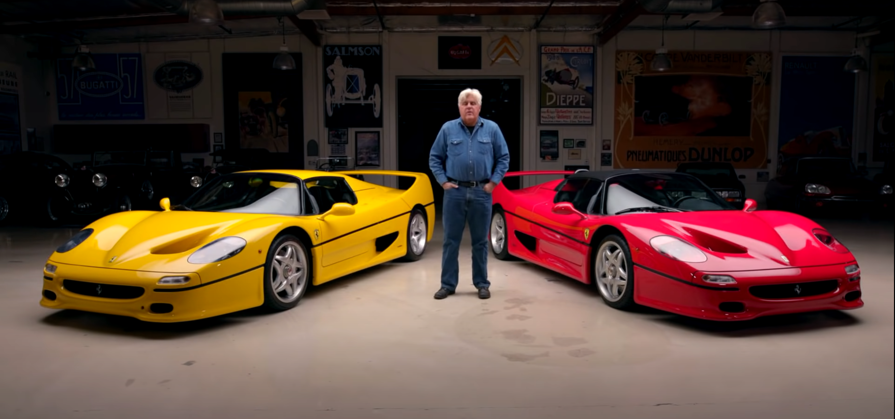 Jay Leno standing in front of yellow and red Ferrari F50