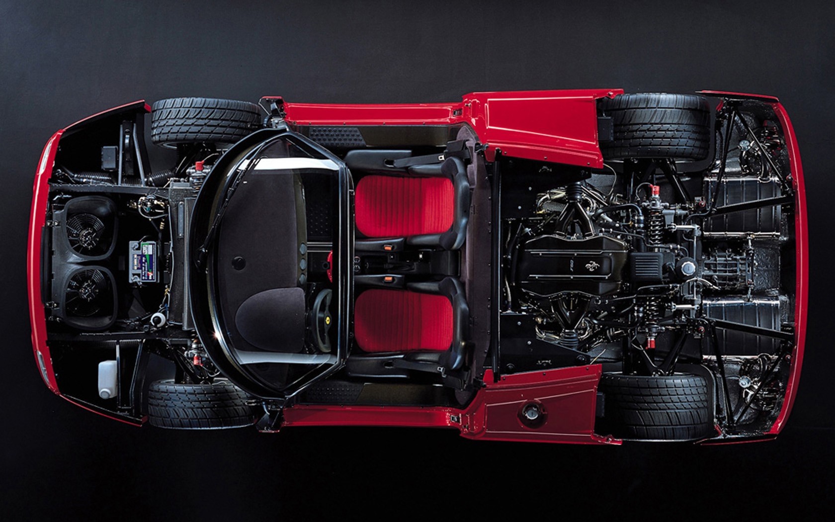 Overhead shot of Ferrari F50 with parts and systems exposed