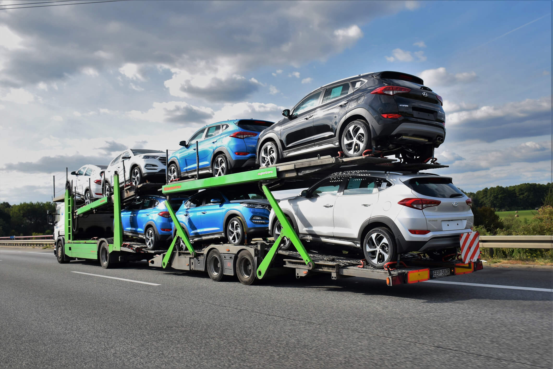 Cars being transported on a double deck trailer