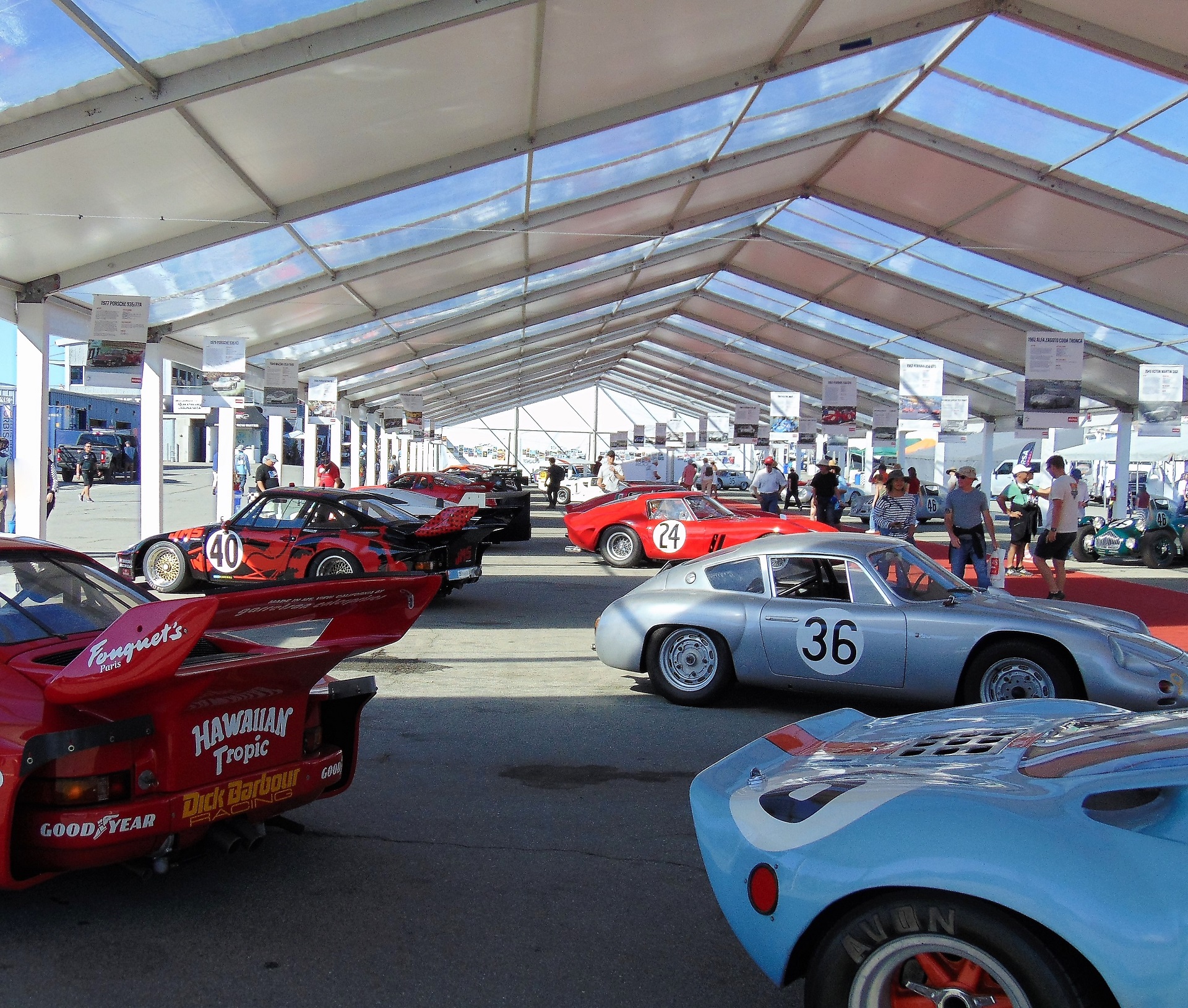 Vintage racecars parked under the paddock tent 