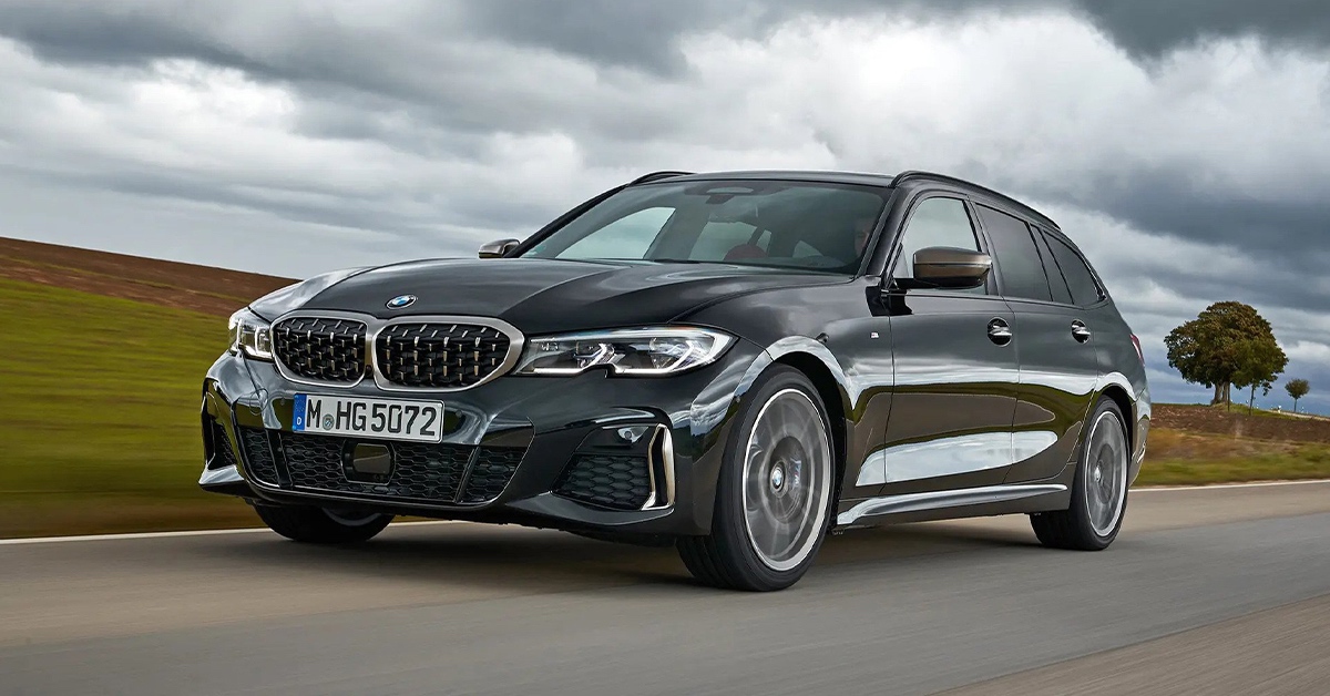 Grey BMW M340i Touring xDrive with cloudy background