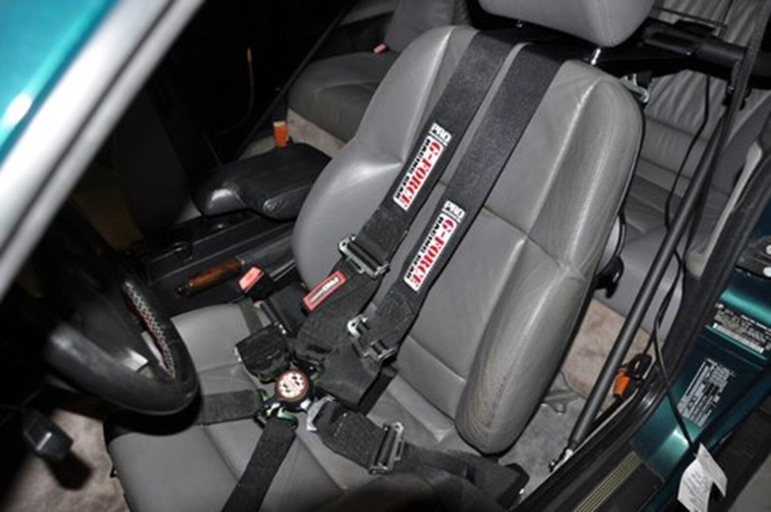 Aftermarket racing harness installed on front seat