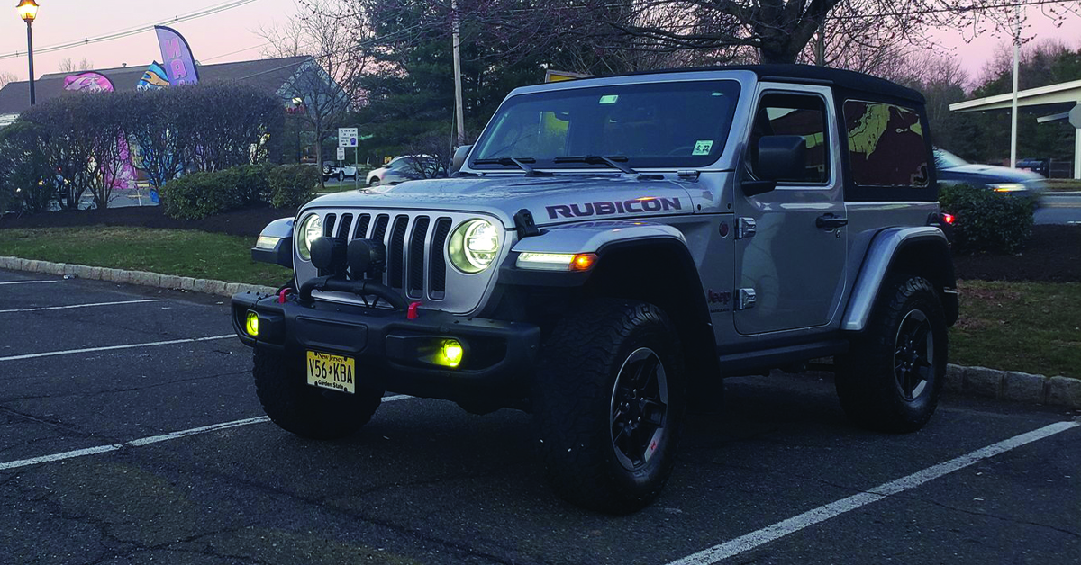 Jeep Rubicon with yellow fog light in parking lot