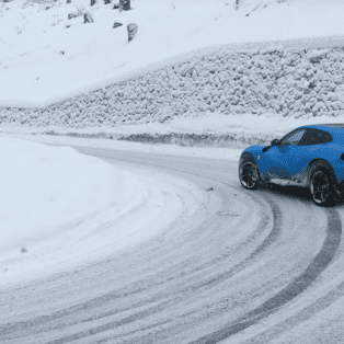 Ferrari Purosangue drifting in the Italian snow