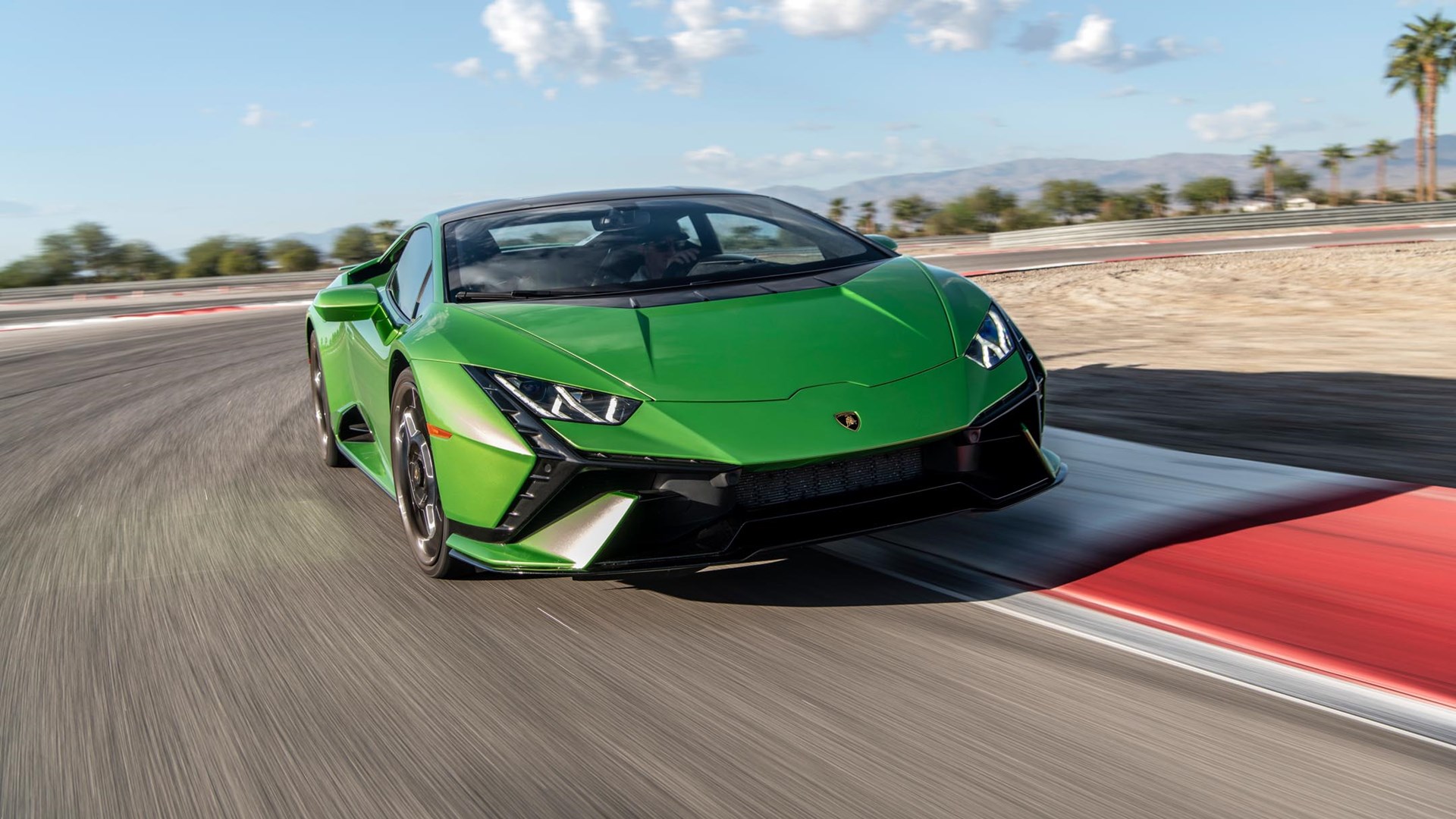 Front angled shot of a green Lamborghini Huracan Tecnica on a race track.