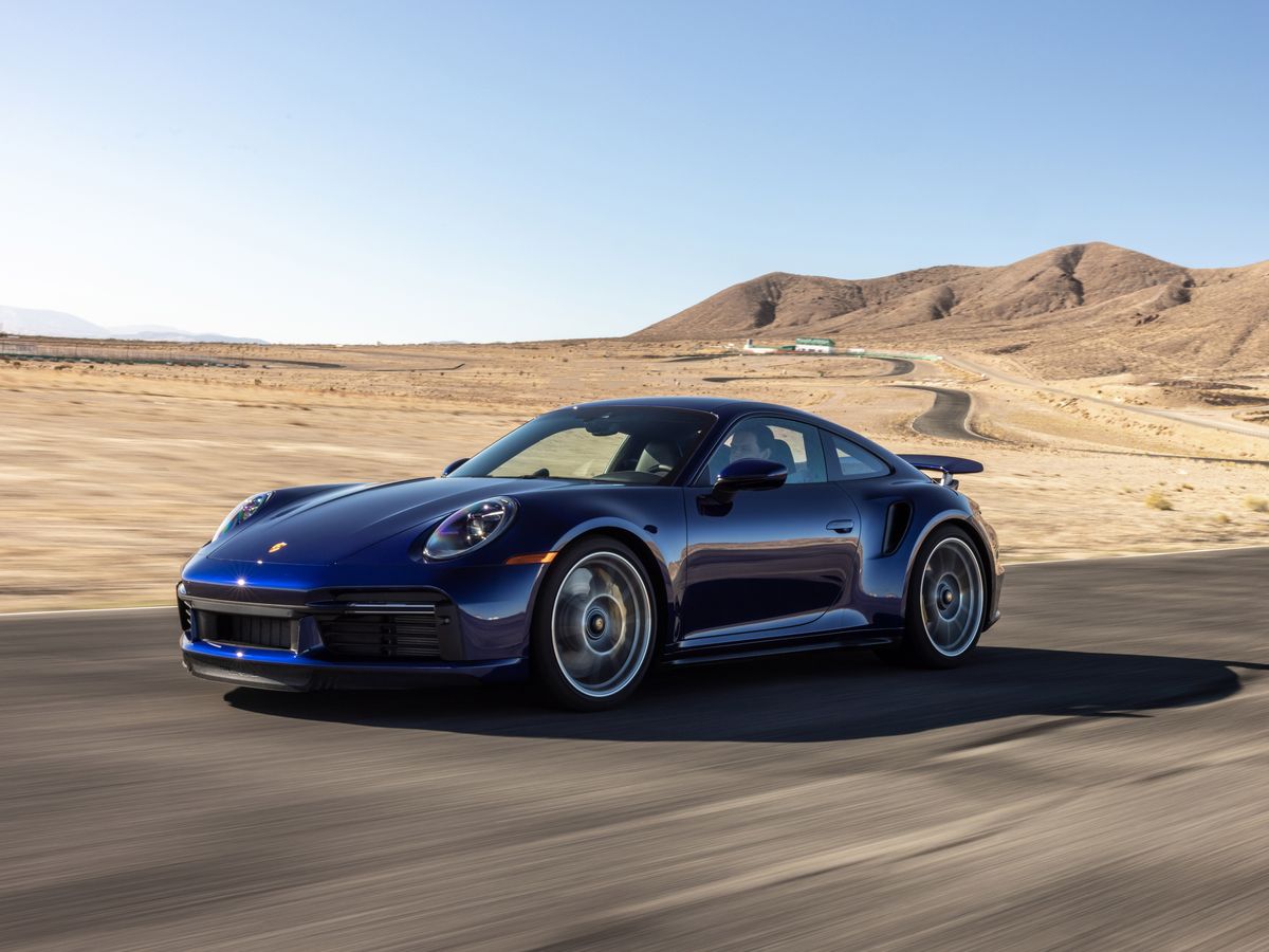 A rolling shot of a blue Porsche 911 Turbo S on the highway