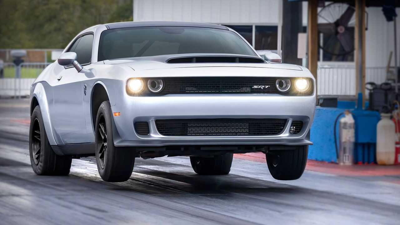 Image of a white Dodge Challenger SRT Demon 170 popping a wheelie at the drag strip.