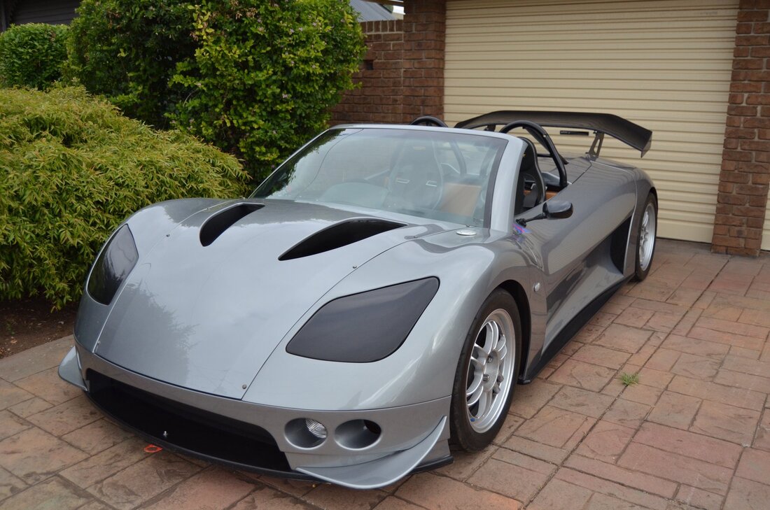 Front-angled shot of a silver BRM Banshee sports car.
