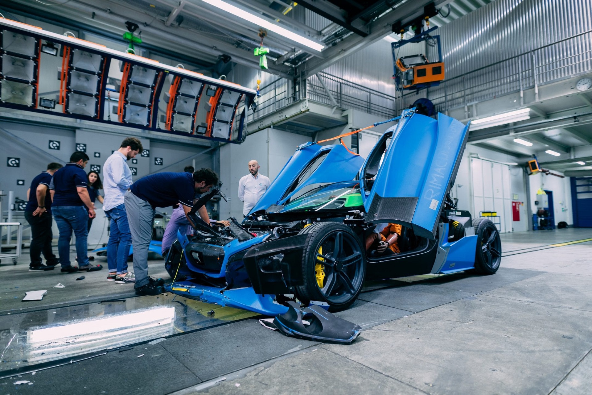 Image showing a blue Rimac Nevera prototype being deliberately crashed as part of its final testing program.