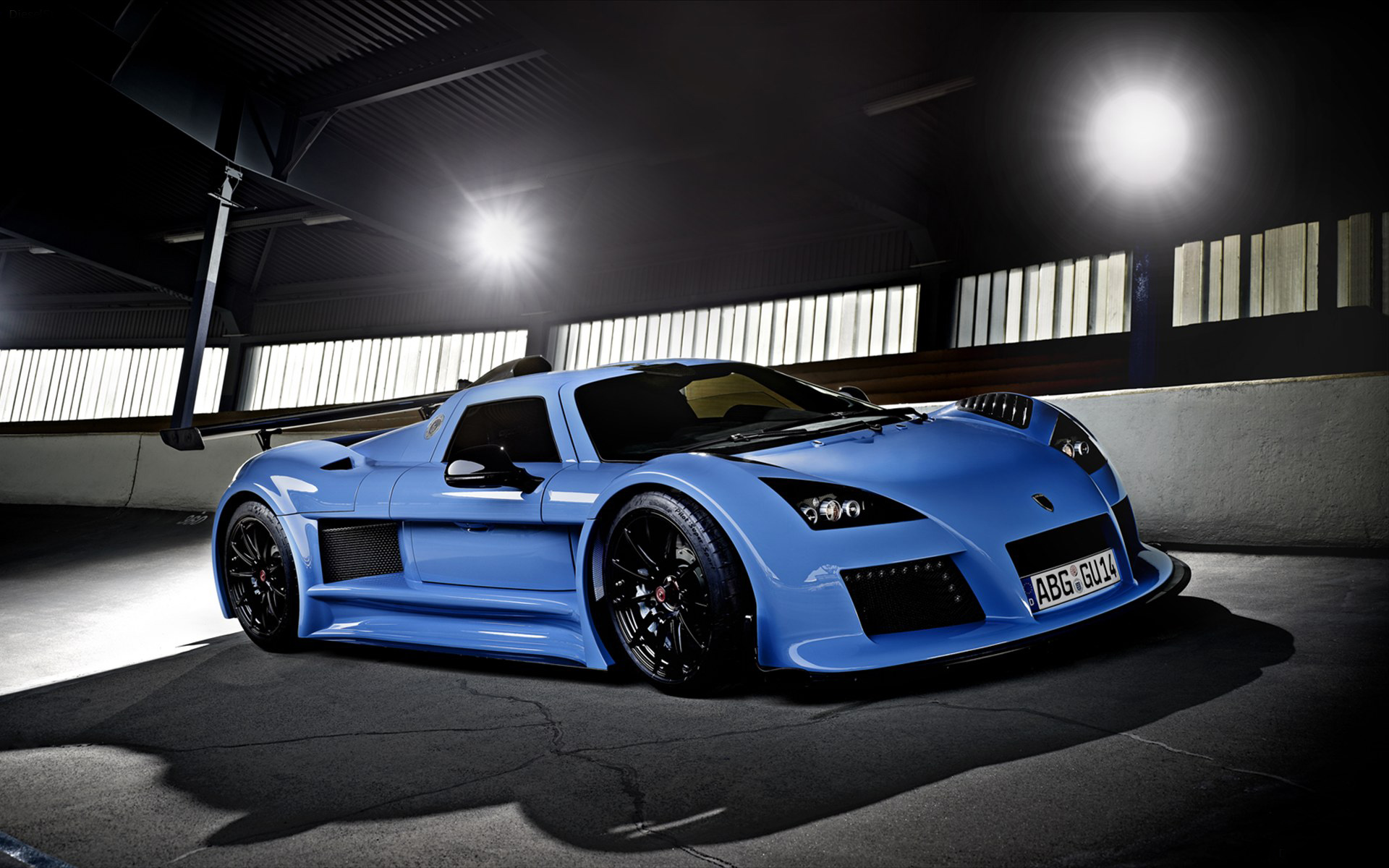 Front angled shot of a blue Gumpert Apollo at night time.