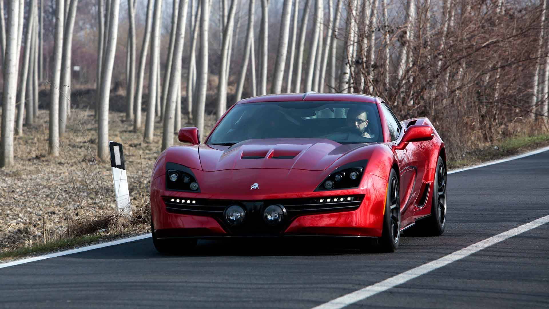 Front-angled shot of a red Equus Throwback sports car.