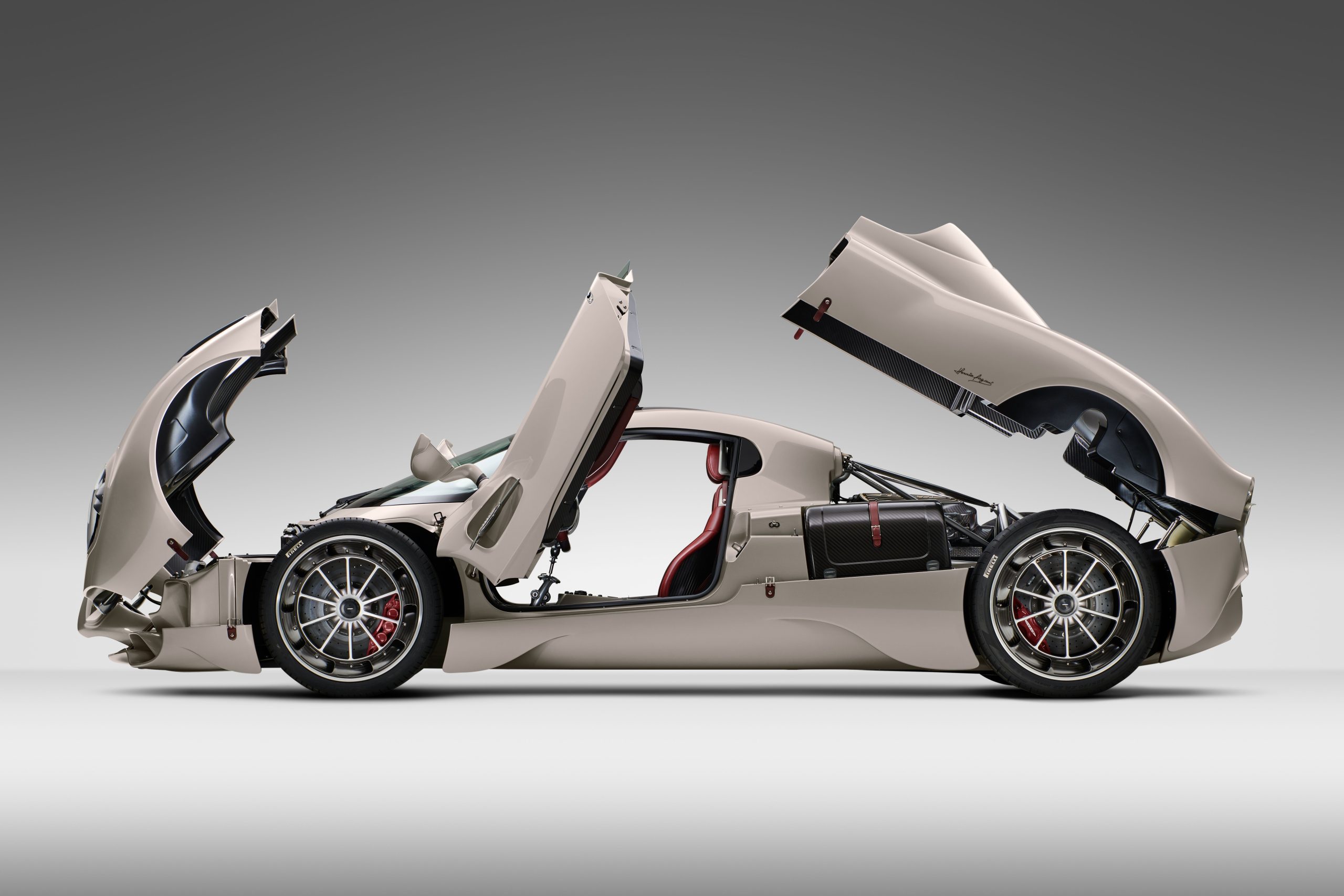 Side profile of the Pagani Utopia hypercar with all doors and hoods open.