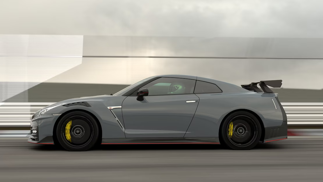 A rolling shot of a grey Nissan GT-R showing its side profile.