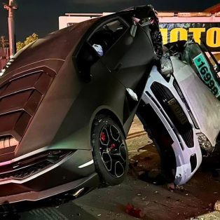 Photo of a black Lambo Aventador crashing into a car dealership in Sydney Australia