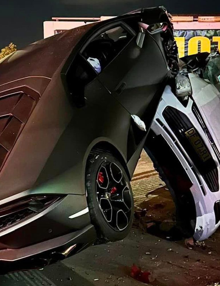 Photo of a black Lambo Aventador crashing into a car dealership in Sydney Australia