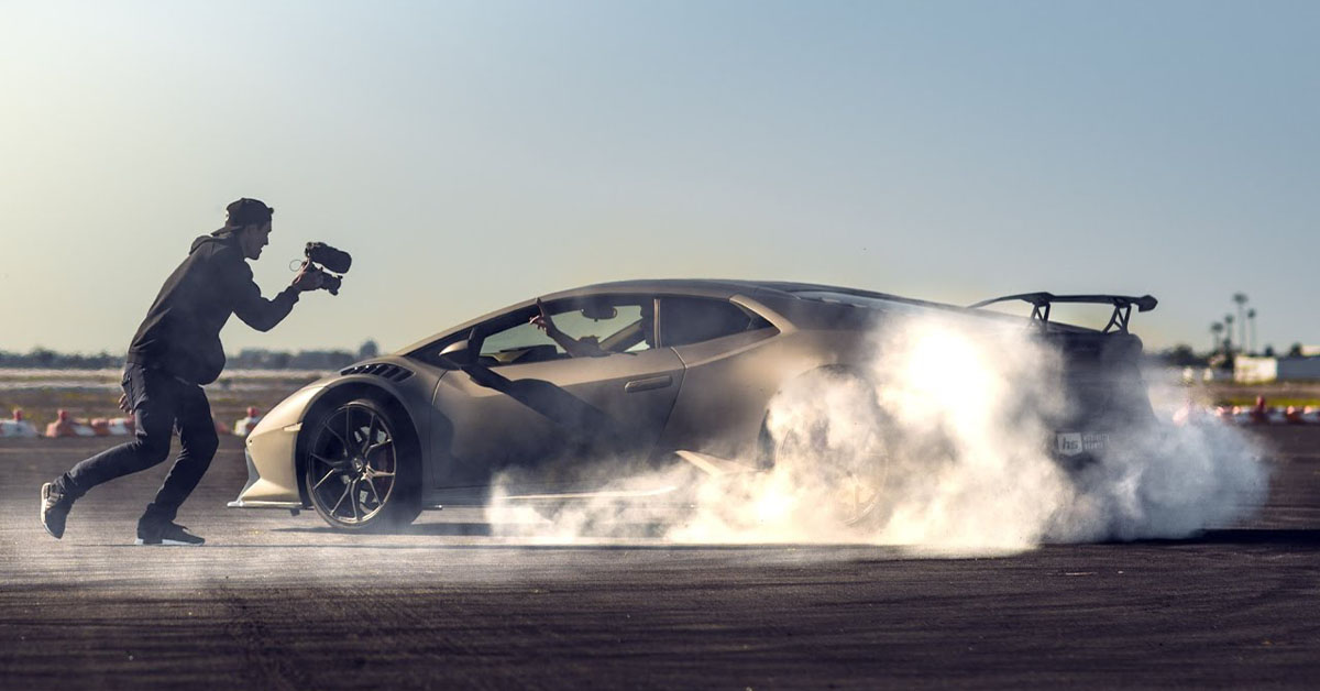 Photo of a gray Lamborghini Huracan drifting on a track