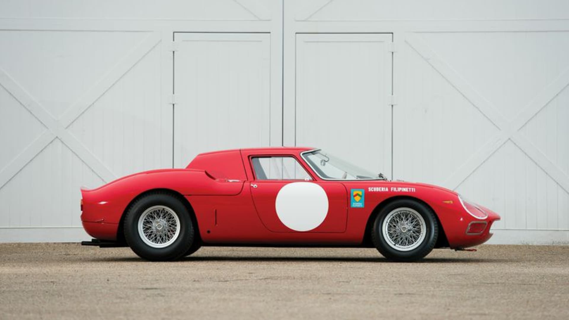 Image showing the side profile of a red 1964 Ferrari 250 LM Coupe.