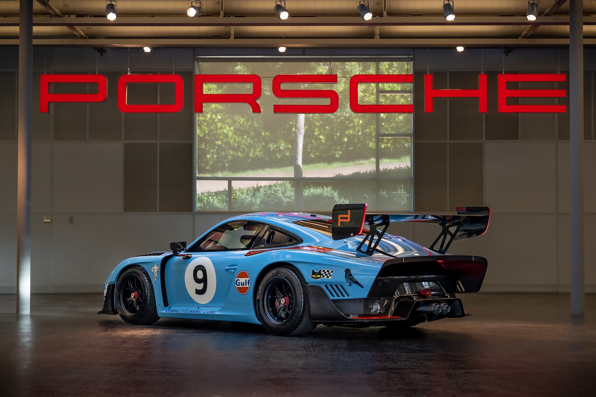 rear-angled view of a Gulf-liveried 2019 Porsche 935