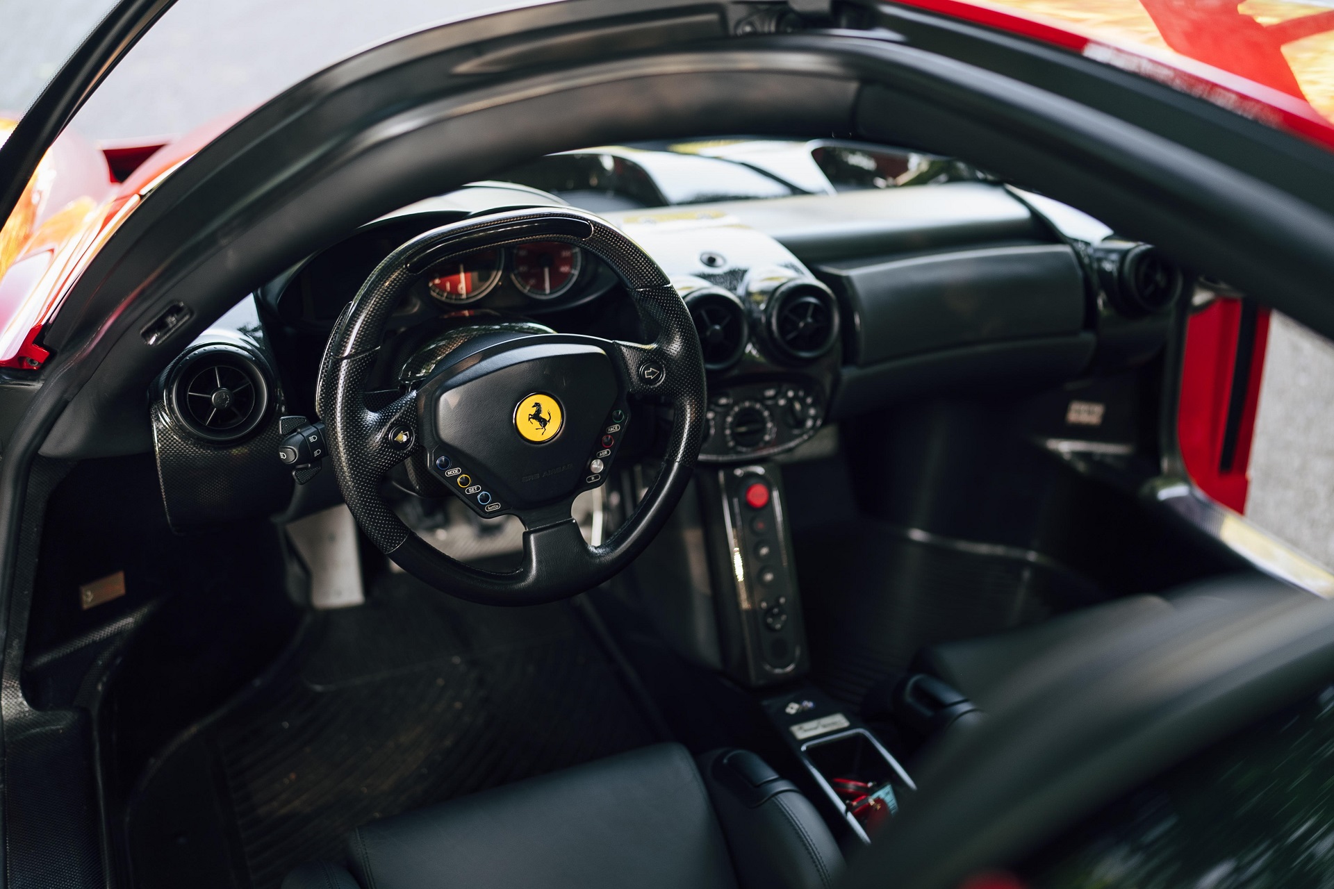 Interior of the red 2003 Ferrari Enzo showing the dashboard.