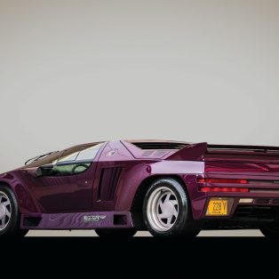 Image showing the rear-angled profile of a purple Vector W8 supercar.