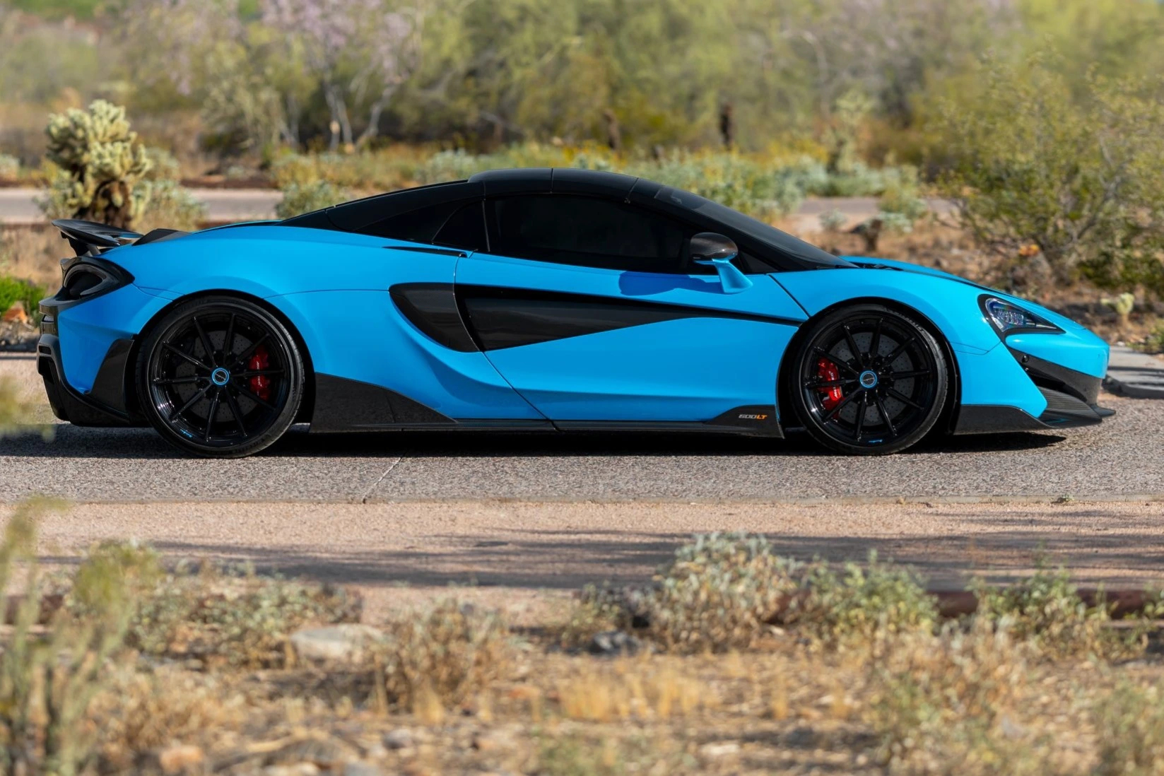 side profile of a blue mclaren 600lt spider