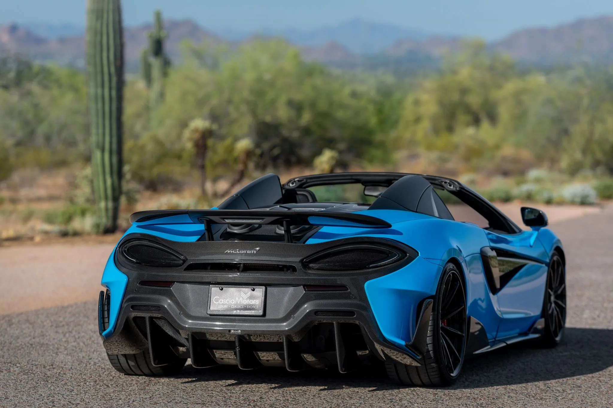 rear-profile of a blue mclaren 600lt spider