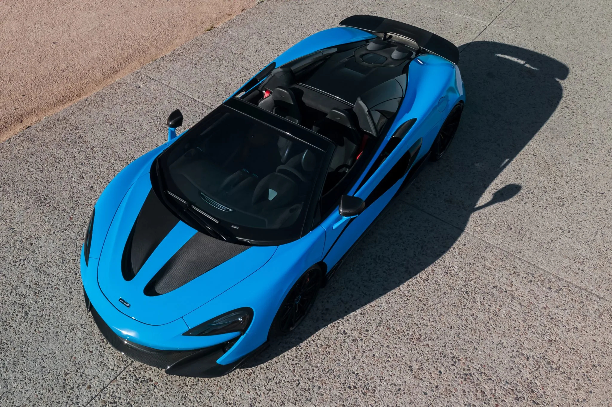 aerial view of a blue McLaren 600LT Spider