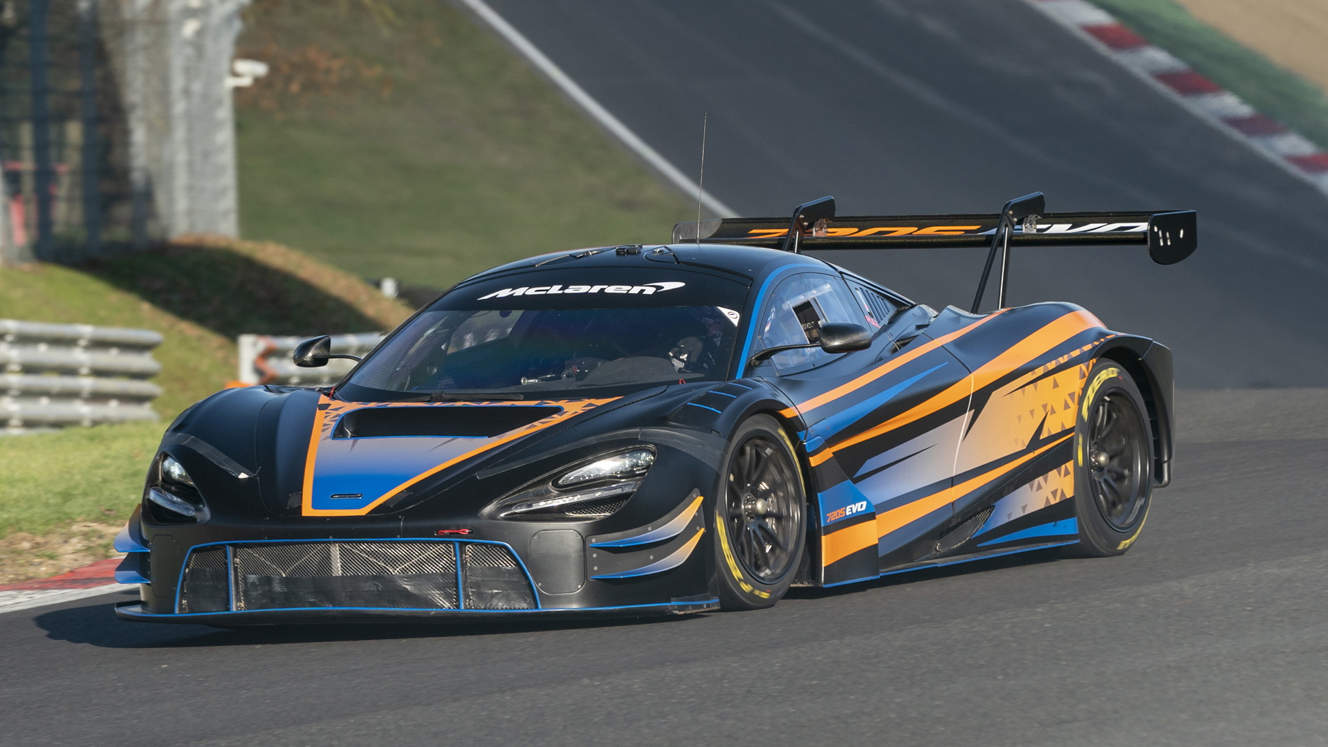 Front-angled view of the McLaren 720S GT3 Evo in race livery out on a race circuit.