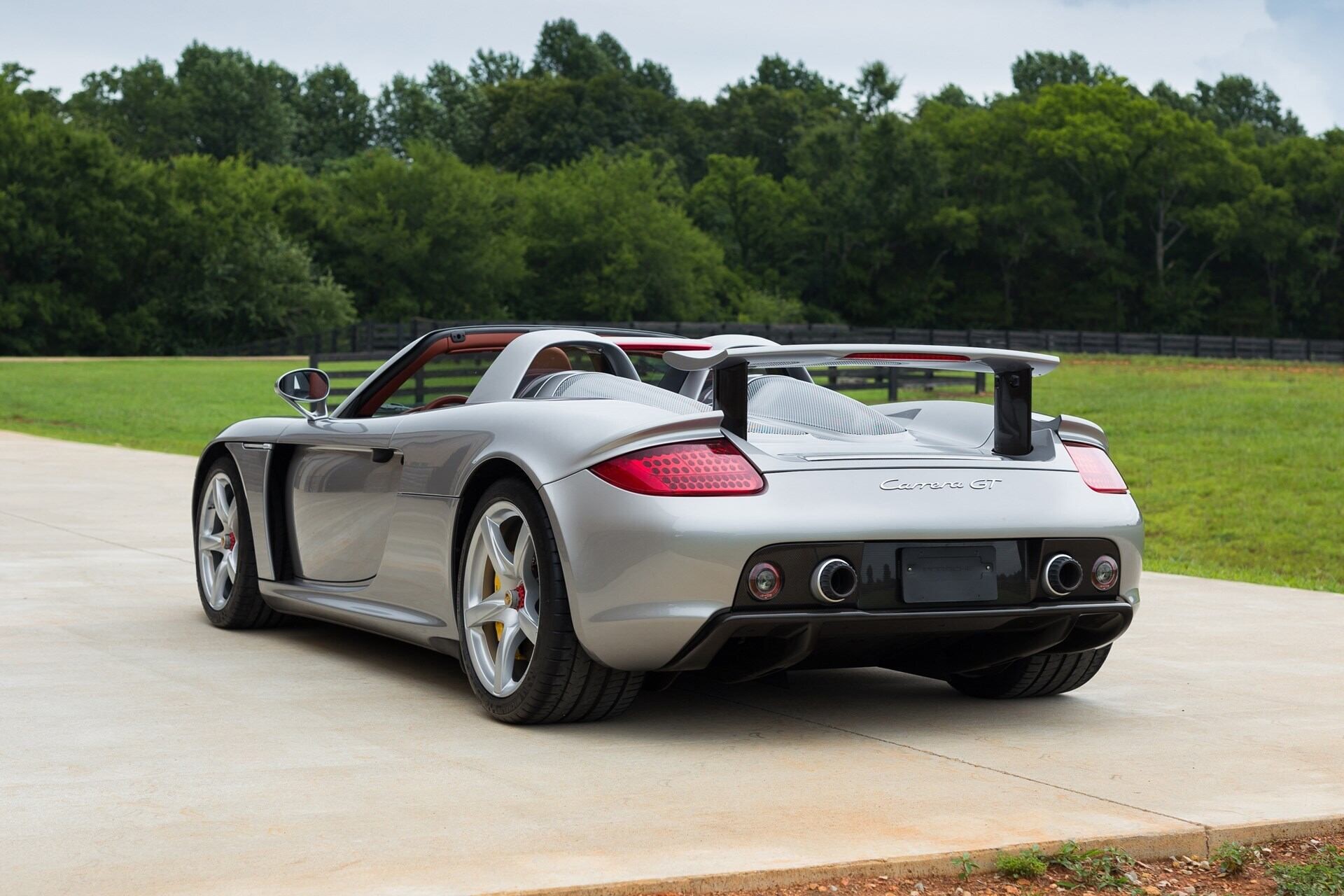 rear-angled view of a silver 2005 Porsche Carrera GT.