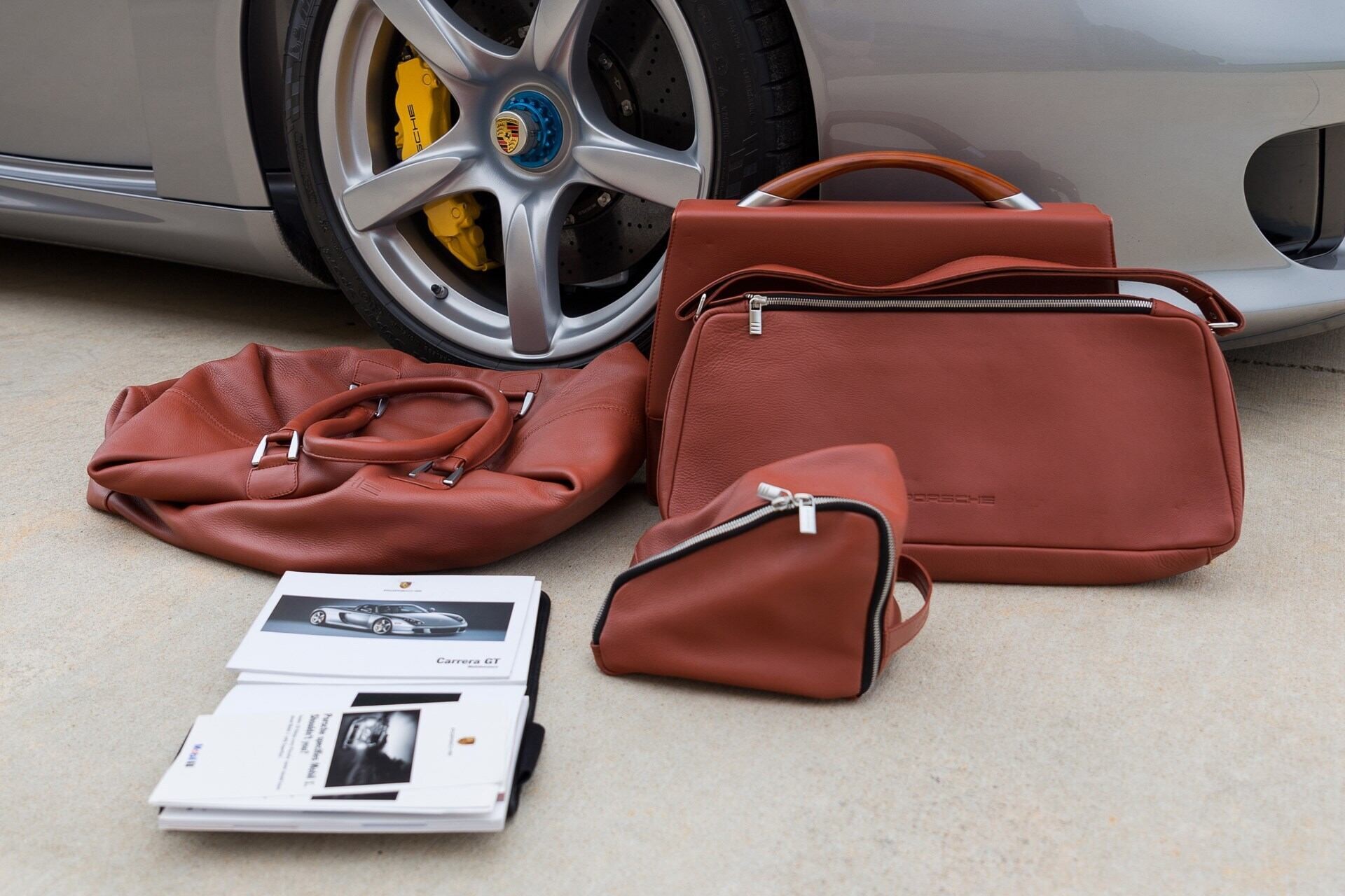 Image showing the owner's manuals and luggage set of a silver 2005 Porsche Carrera GT
